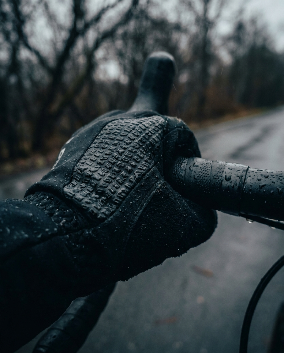 Anti-slip grip palm cycling gloves on handlebars - non-slip texture in wet conditions