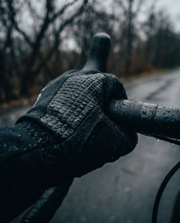 Anti-slip grip palm cycling gloves on handlebars - non-slip texture in wet conditions